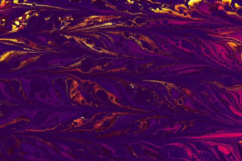 A vivid abstract pattern with purple and gold swirls, perfect for backgrounds or artistic design.